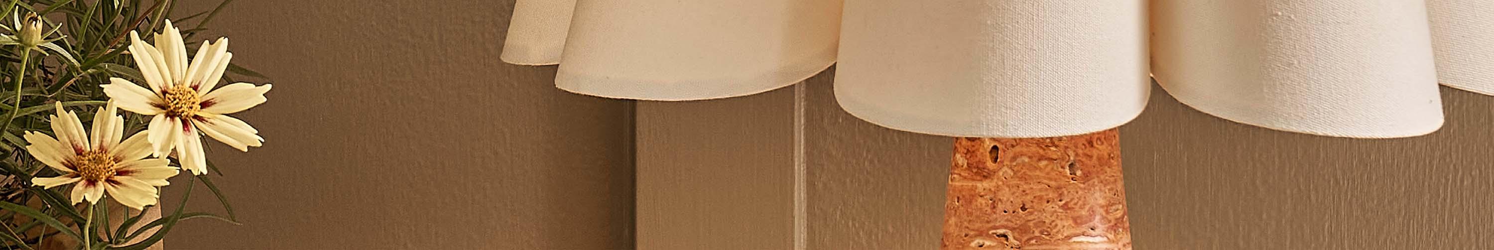 Red marble and white lamp next to flowers